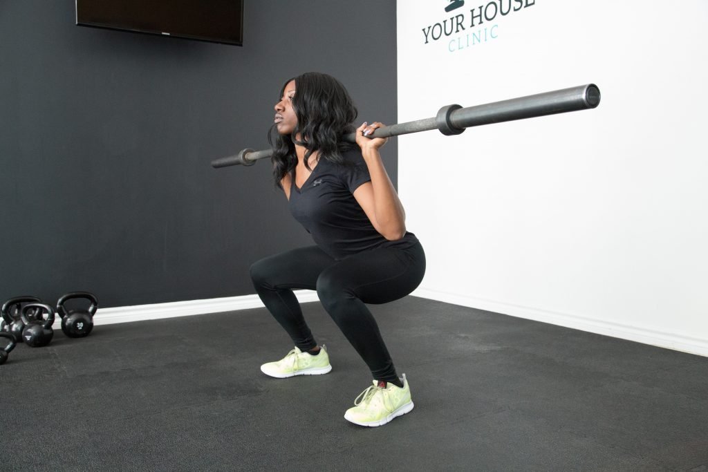 Woman squats with weights