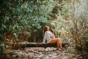 Pregnant woman relaxing in the forest.
