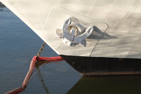The nose of the ship white, on-berth at anchor