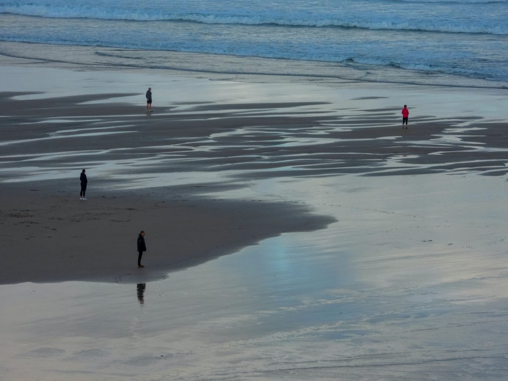 Calmness and Still life: four persons standing on seashore during day