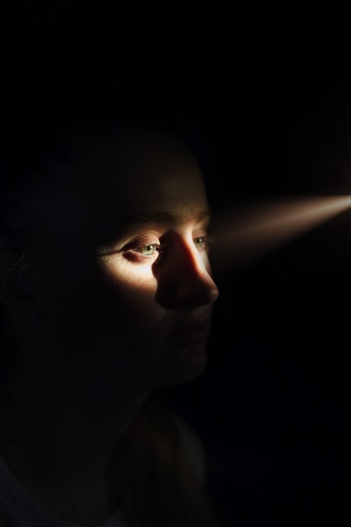 woman's face with sunlight on eyes