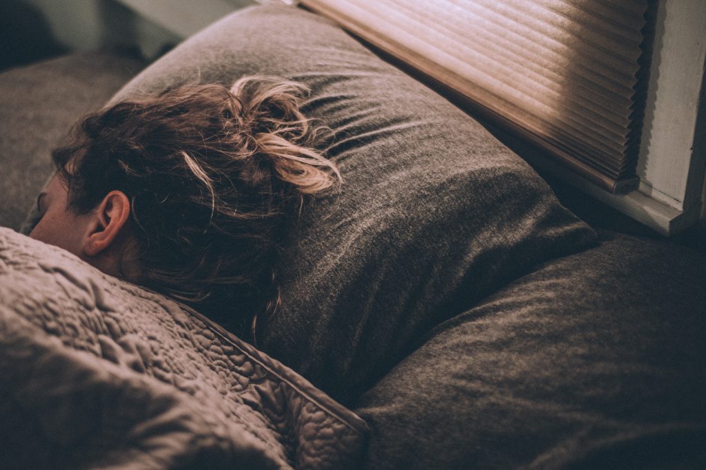 woman sleeping on bed under blankets: recovering from empty yin