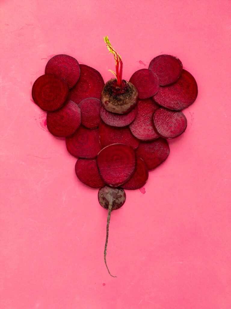 red heart shaped decors on pink wall: beetroot turns phlegm colour purple