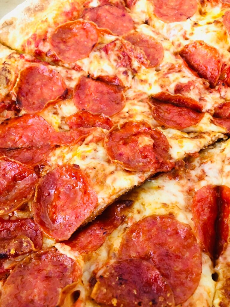 pepperoni pizza on white ceramic plate