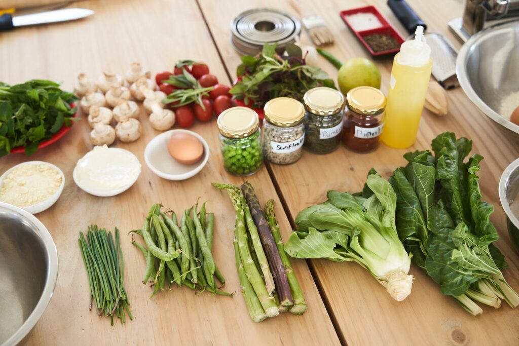 green vegetable on brown wooden table. Vegetables benefit dry skin.
