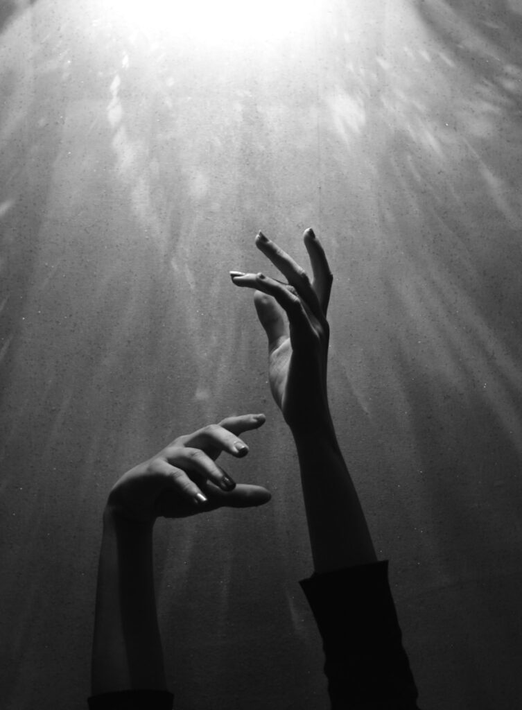 person raising both hands from dark yin-excess towards yang light and energy